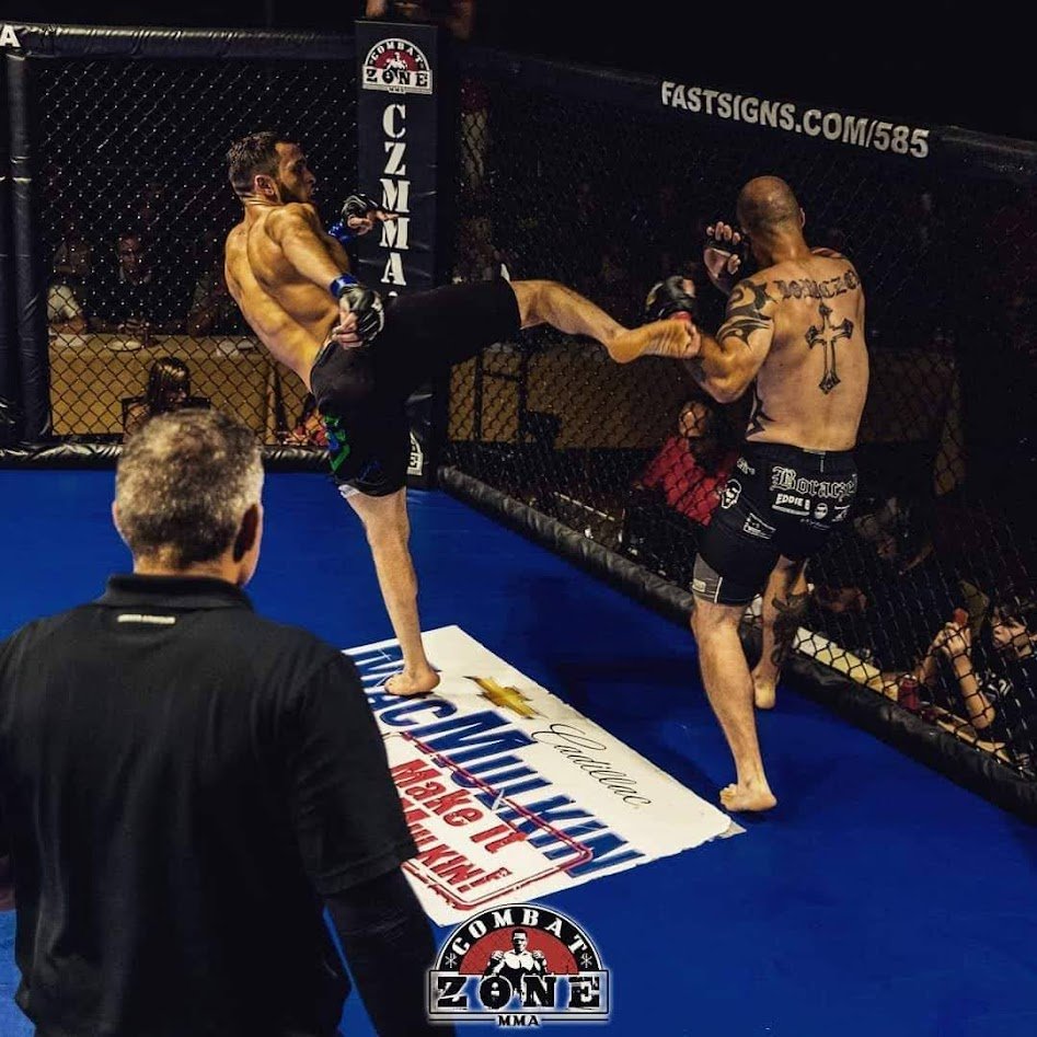 Duncan delivering a kick during an MMA fight